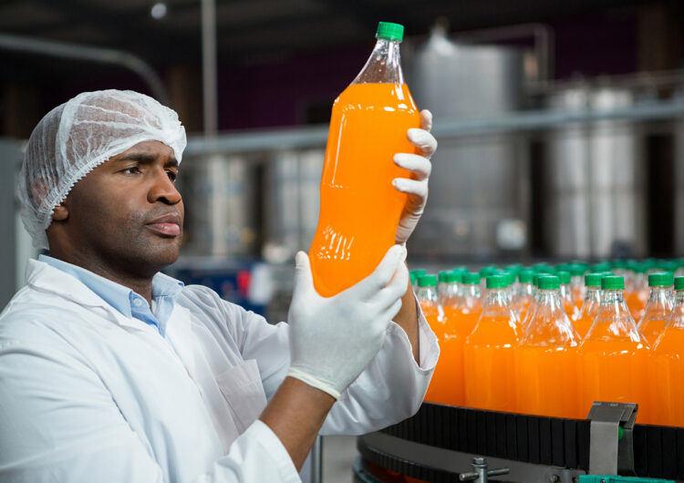 male-worker-checking-products-juice-factory